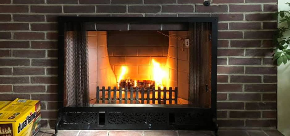 Stock Photo- Fireplace-Frechette Chimney Sweeping and Lining- Sanford ME Fireplace burning with bricks on the side